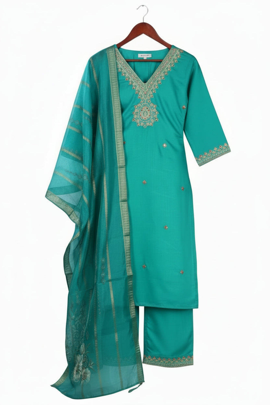 Woman wearing a teal embroidered outfit with a digital duppata, posing indoors.