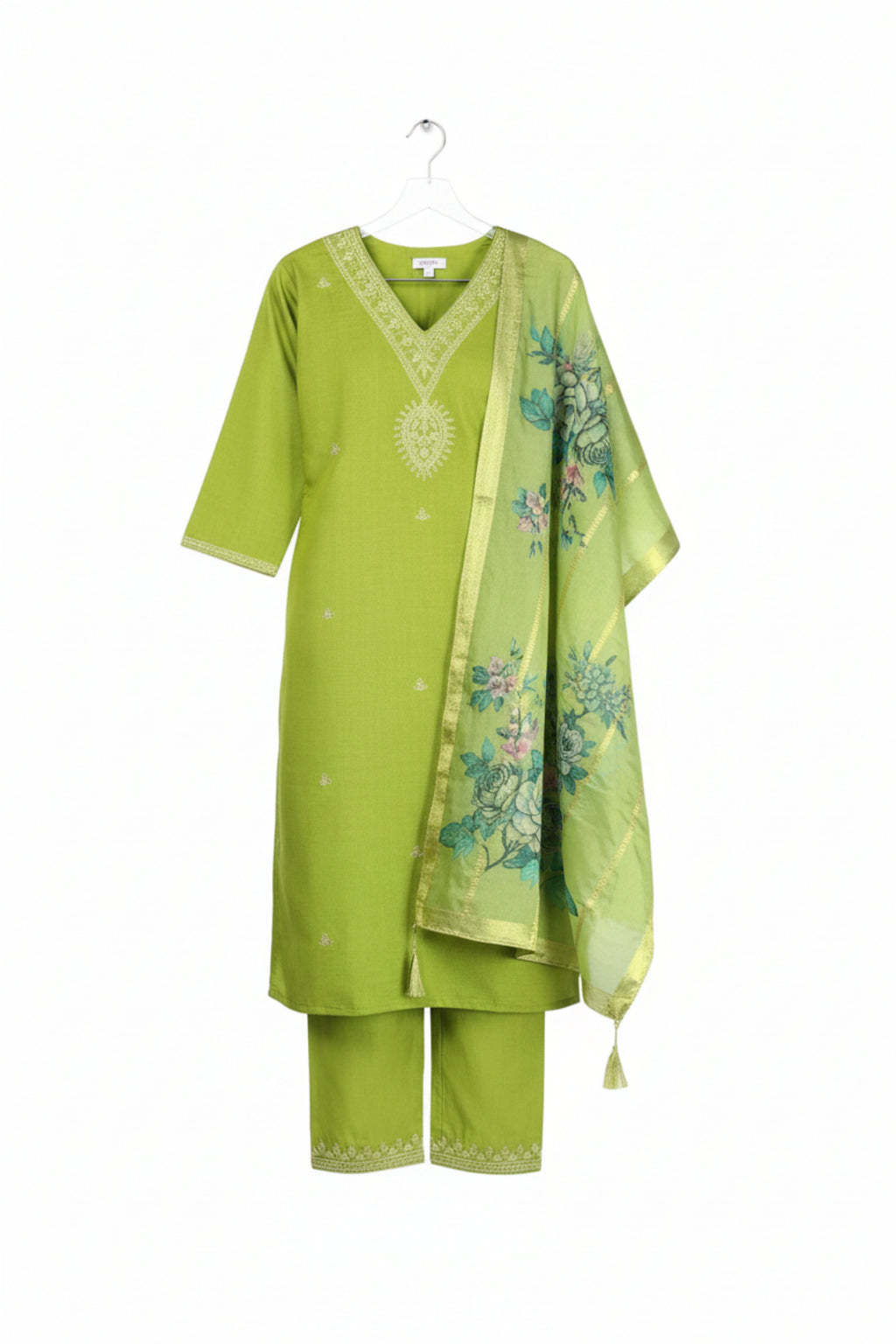 Woman wearing a green traditional outfit with a matching dupatta, posing indoors.