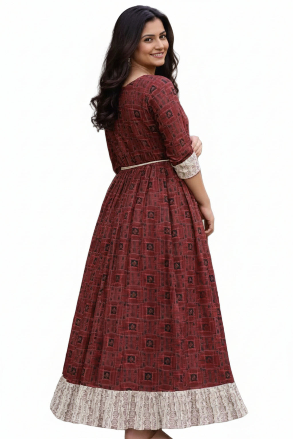Woman wearing a red patterned dress with a blurred natural background