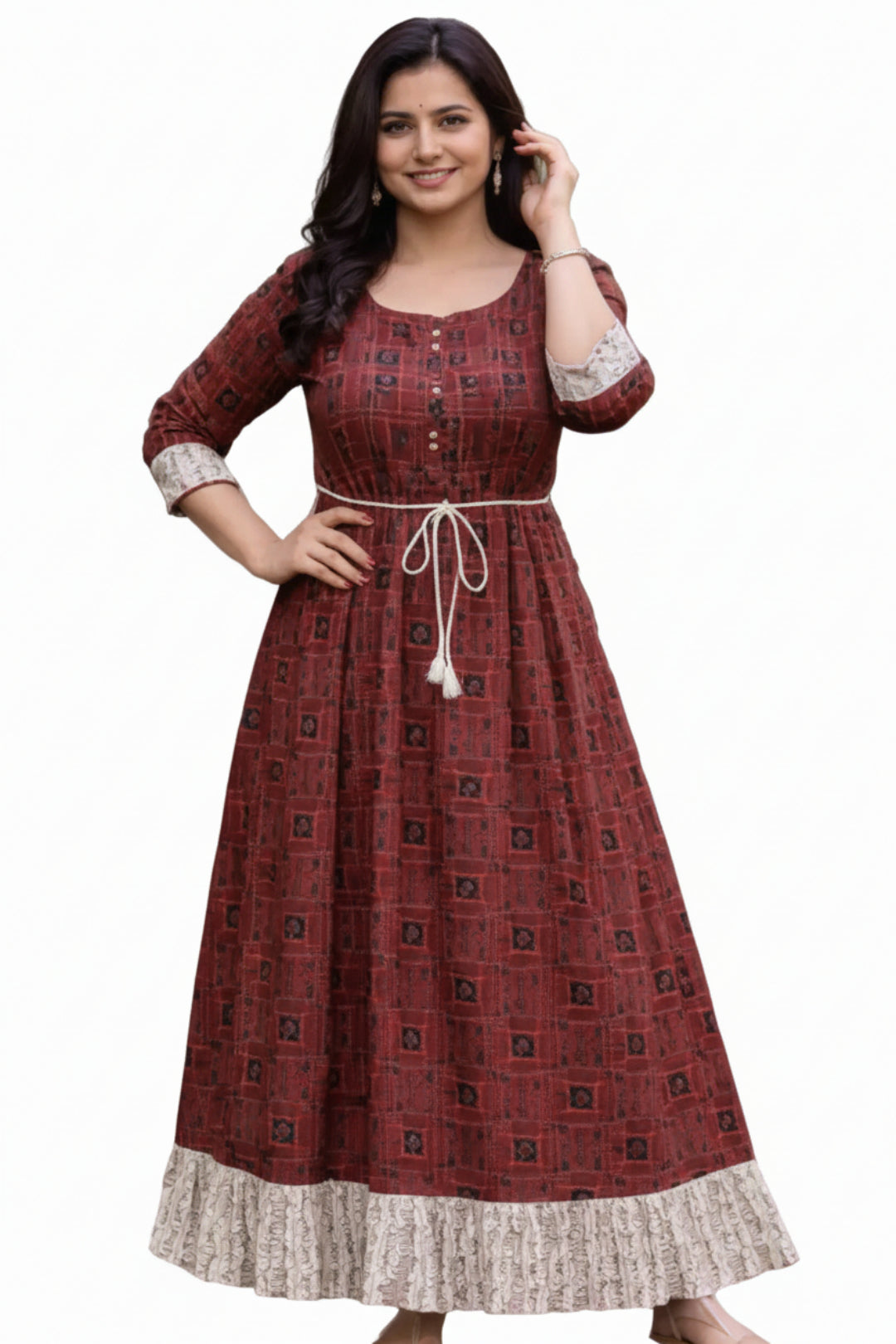Woman wearing a patterned red dress standing outdoors on a wooden path.