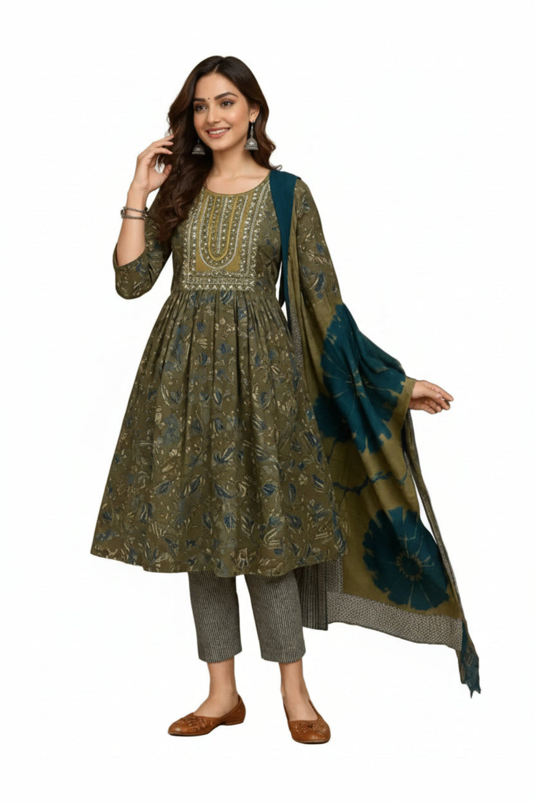Woman wearing a traditional outfit with a green and blue dupatta in a decorated room.