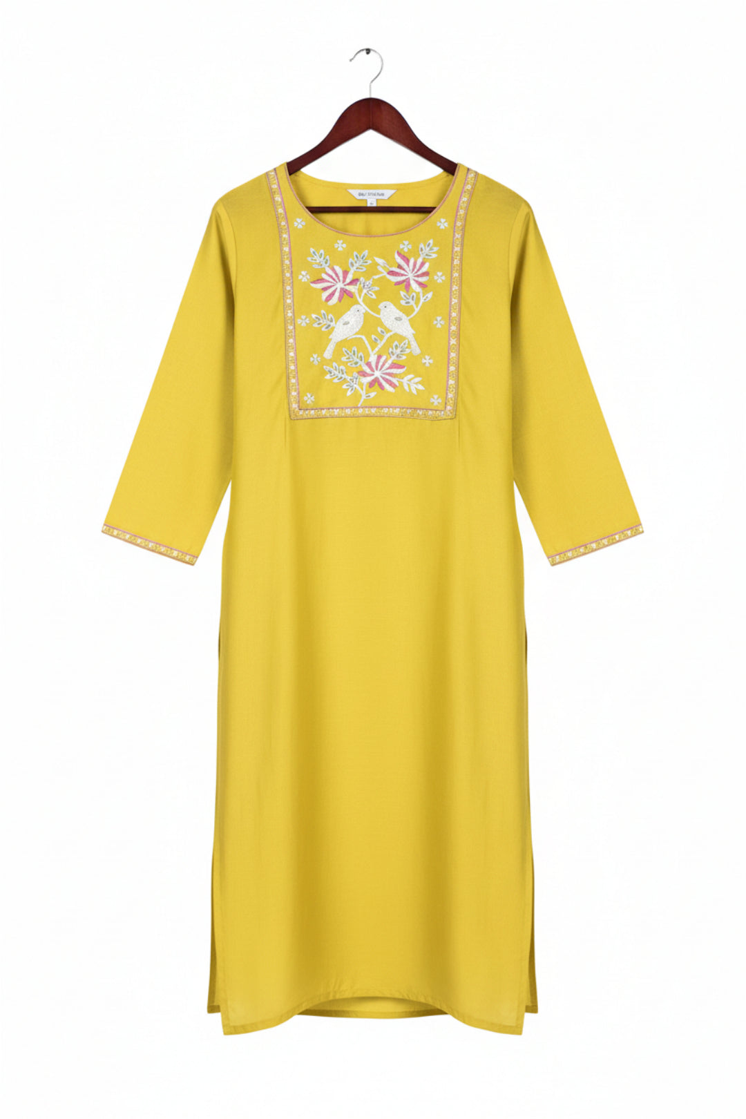 Two women wearing yellow embroidered kurtis on a white background