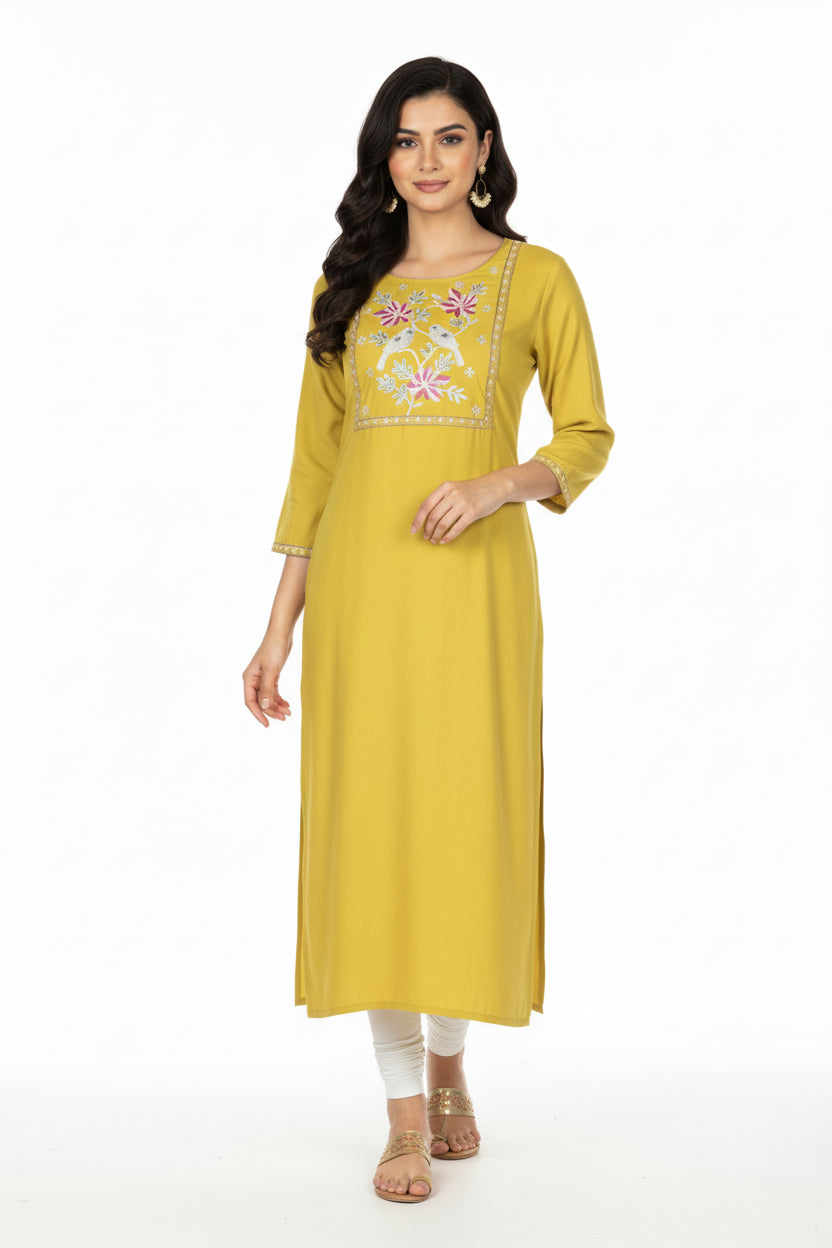 Woman wearing a yellow kurta with floral embroidery on a white background