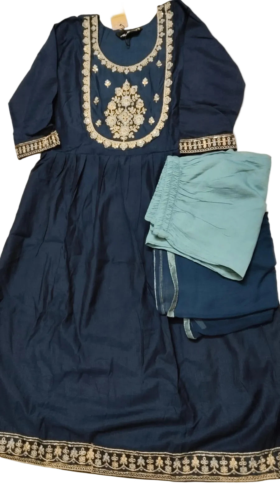 Navy blue traditional outfit with gold embroidery and light blue pants on a white background
