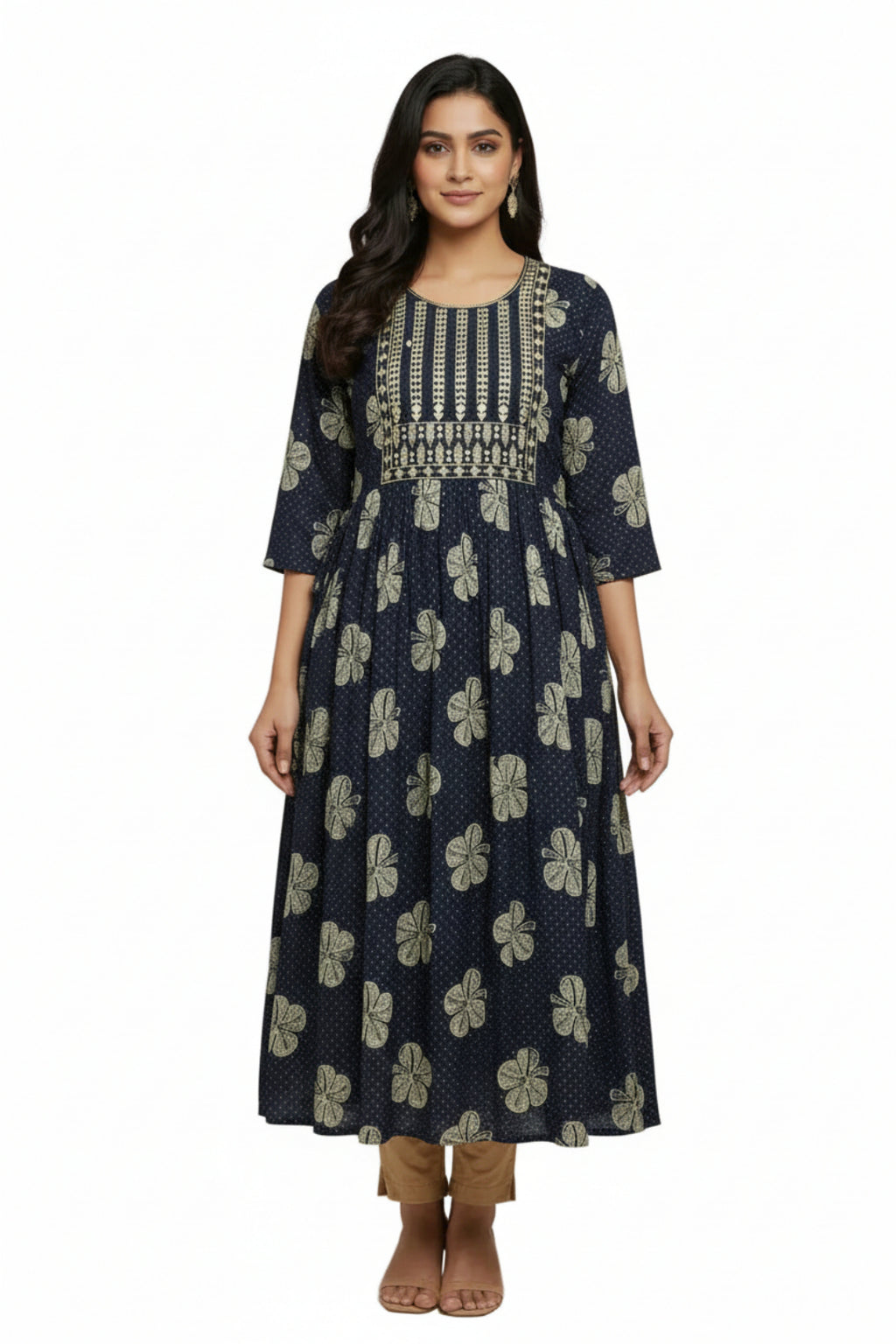 Woman wearing a navy blue floral dress with intricate patterns on a plain background