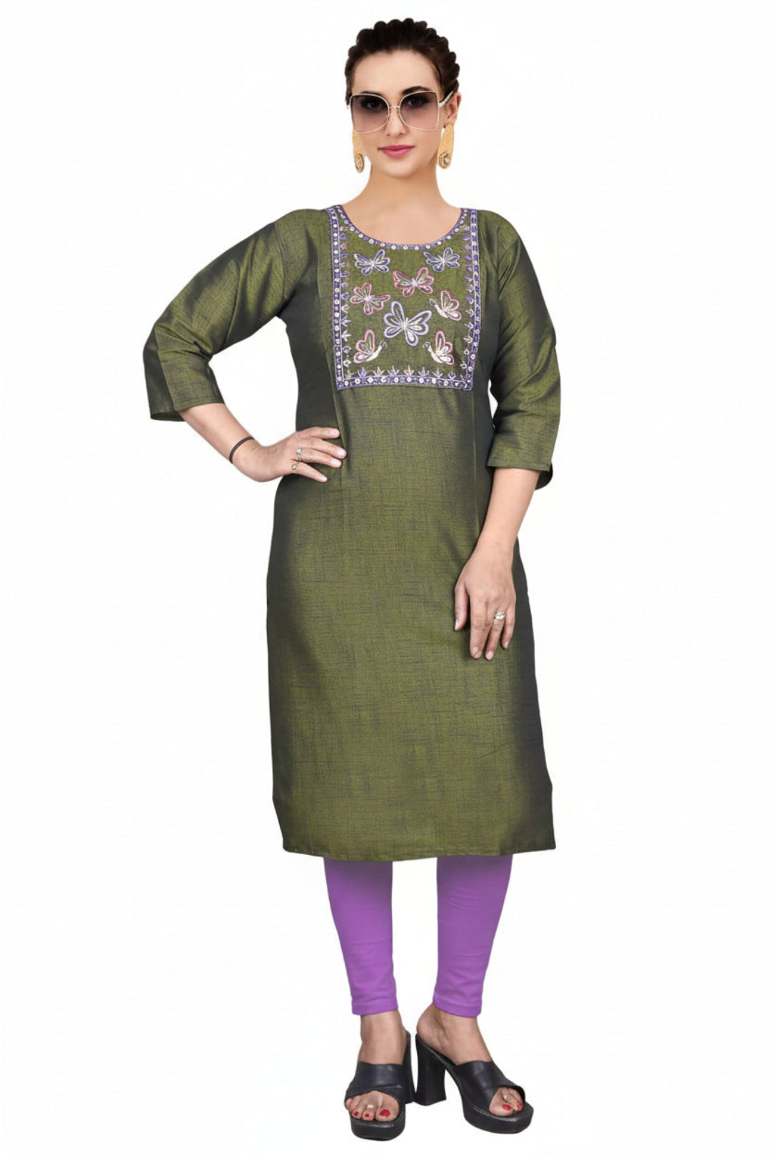 Two women wearing green embroidered kurtis with a white background