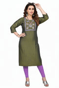 Woman wearing a green embroidered kurta with purple leggings on a white background