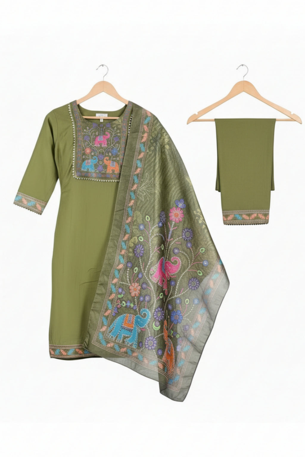 Woman wearing a green traditional outfit with floral patterns on a white background