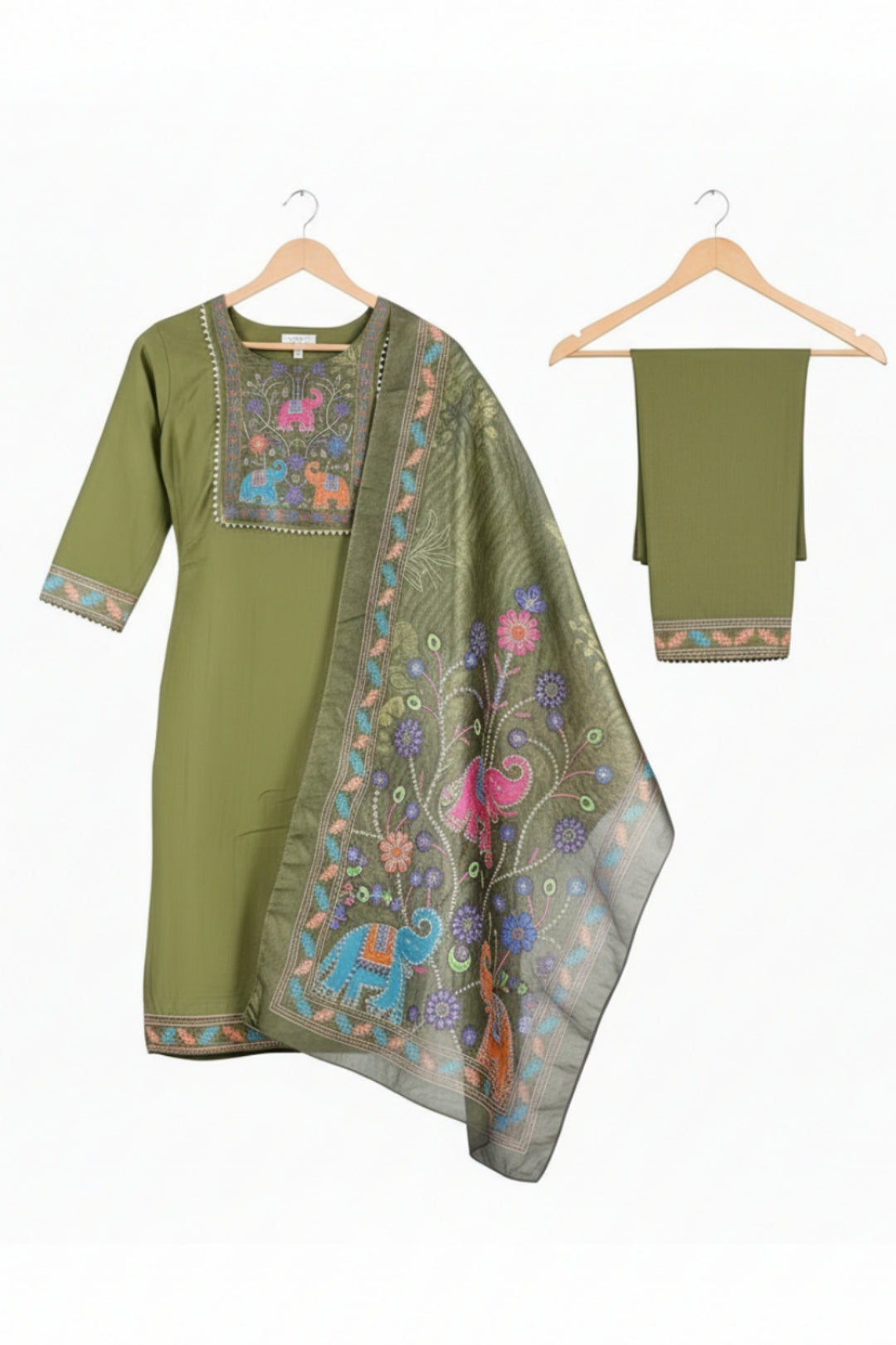 Woman wearing a green traditional outfit with floral patterns on a white background
