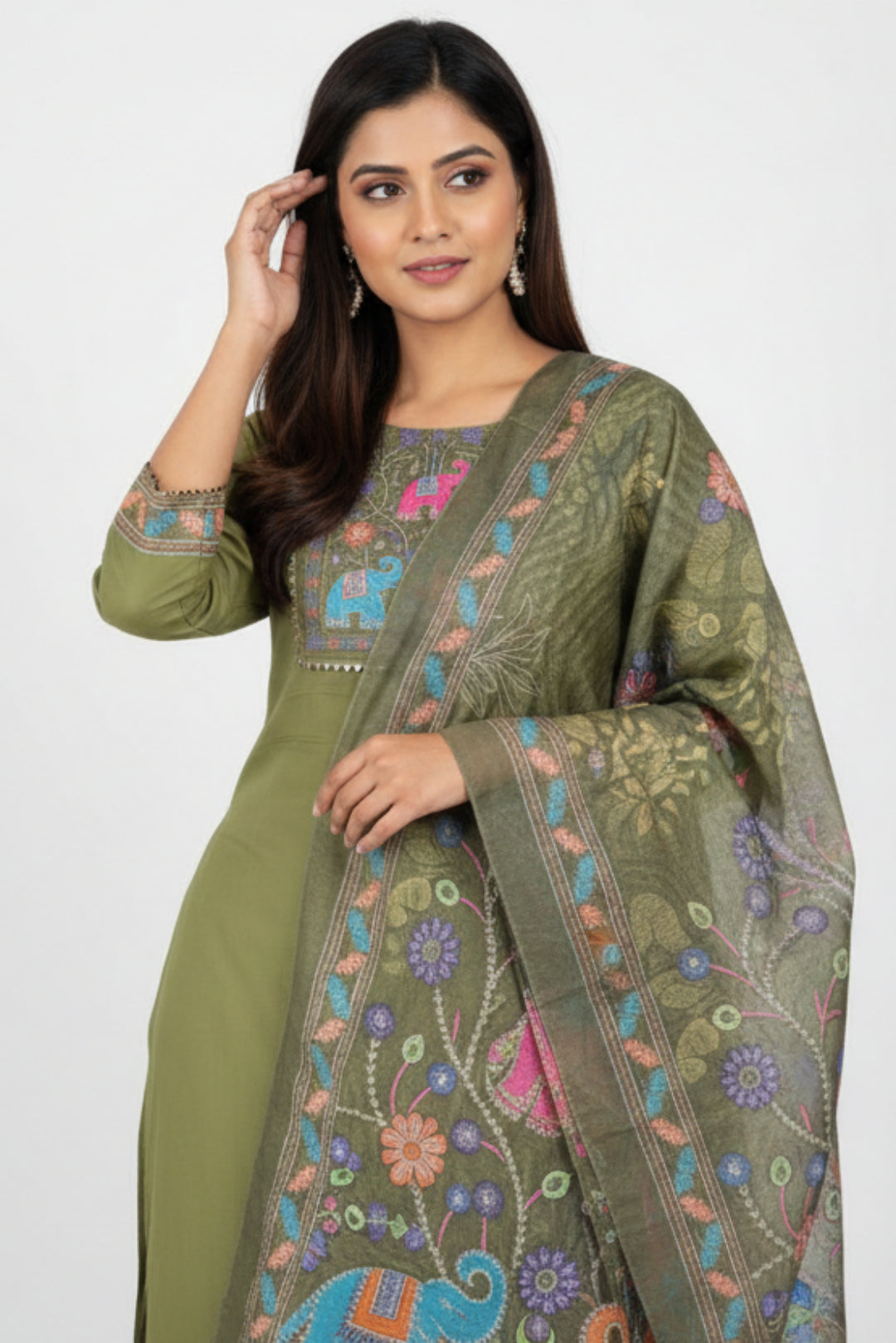 Green embroidered outfit with matching dupatta on hangers against a white background