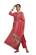 Woman wearing a pink traditional outfit with elephant design, holding a dupatta.