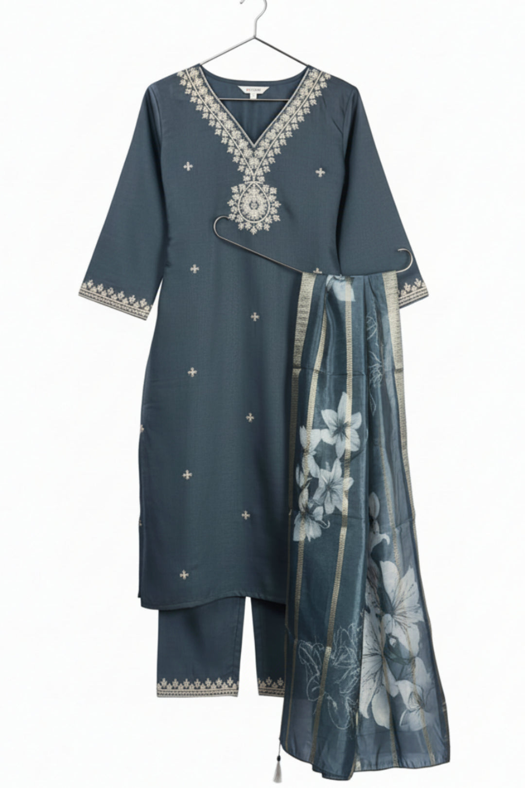 Woman wearing a gray traditional outfit with a floral dupatta on a white background