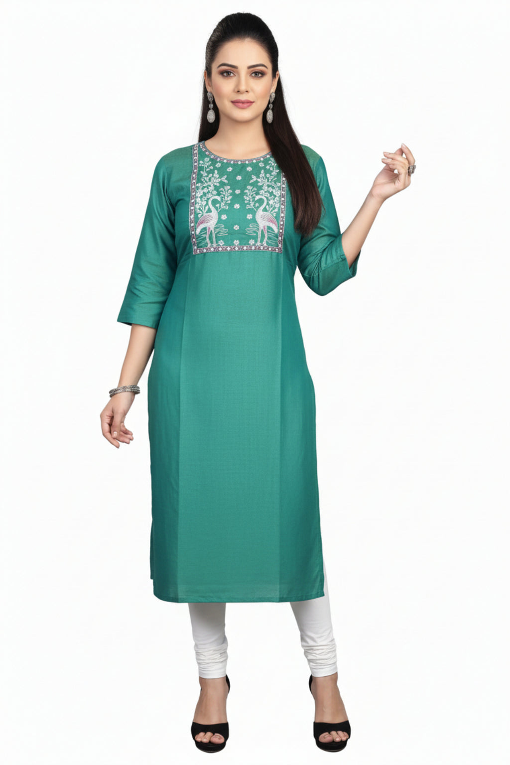 Green embroidered kurta with white pants worn by a model on a pink background