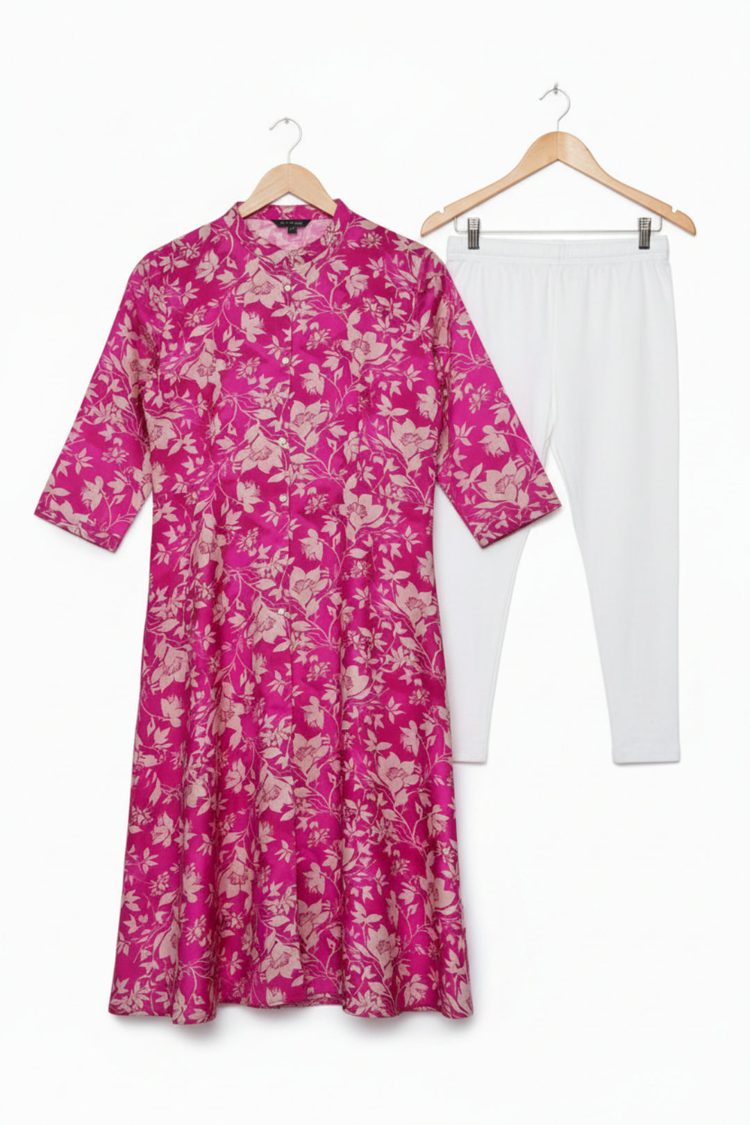 Pink floral dress on a white background with a visible brand label.
