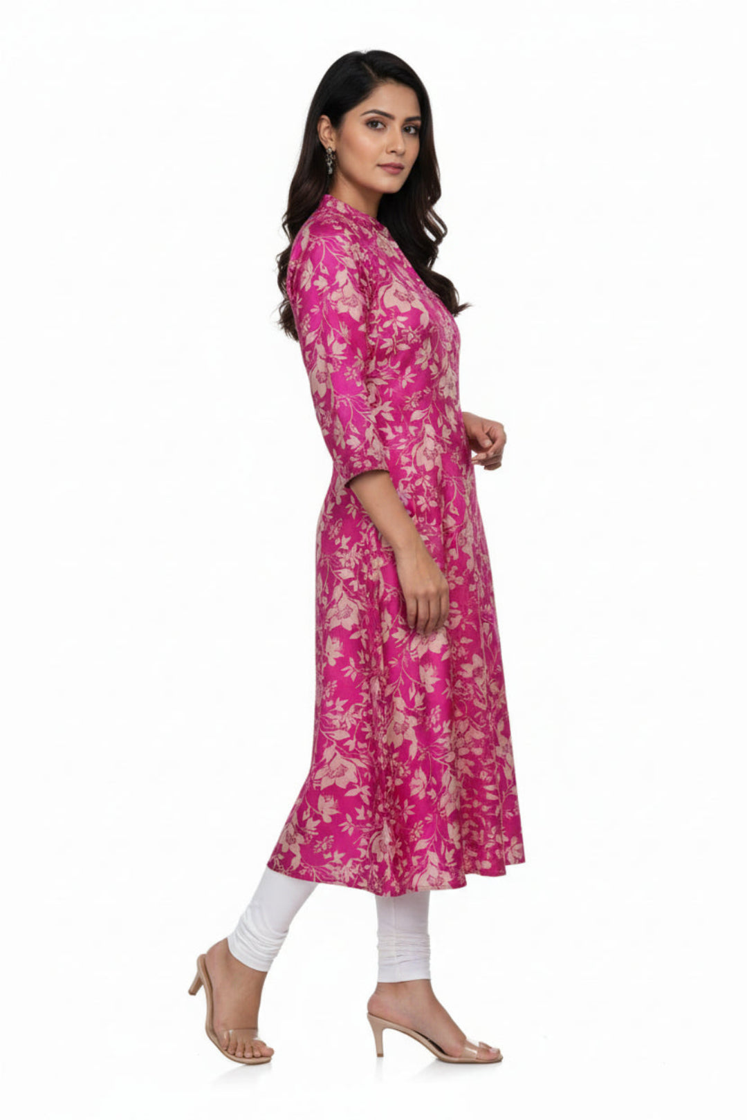 Pink floral dress on a hanger against a white background