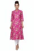 Pink floral dress on a hanger against a white background