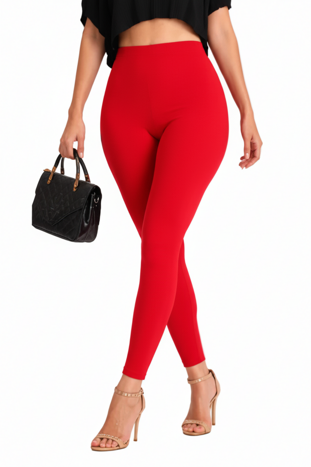 Person wearing red leggings with a black top and high-heeled shoes on a white background