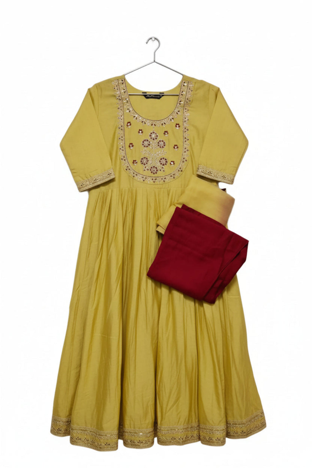Yellow dress with intricate embroidery and a red pant on a white background